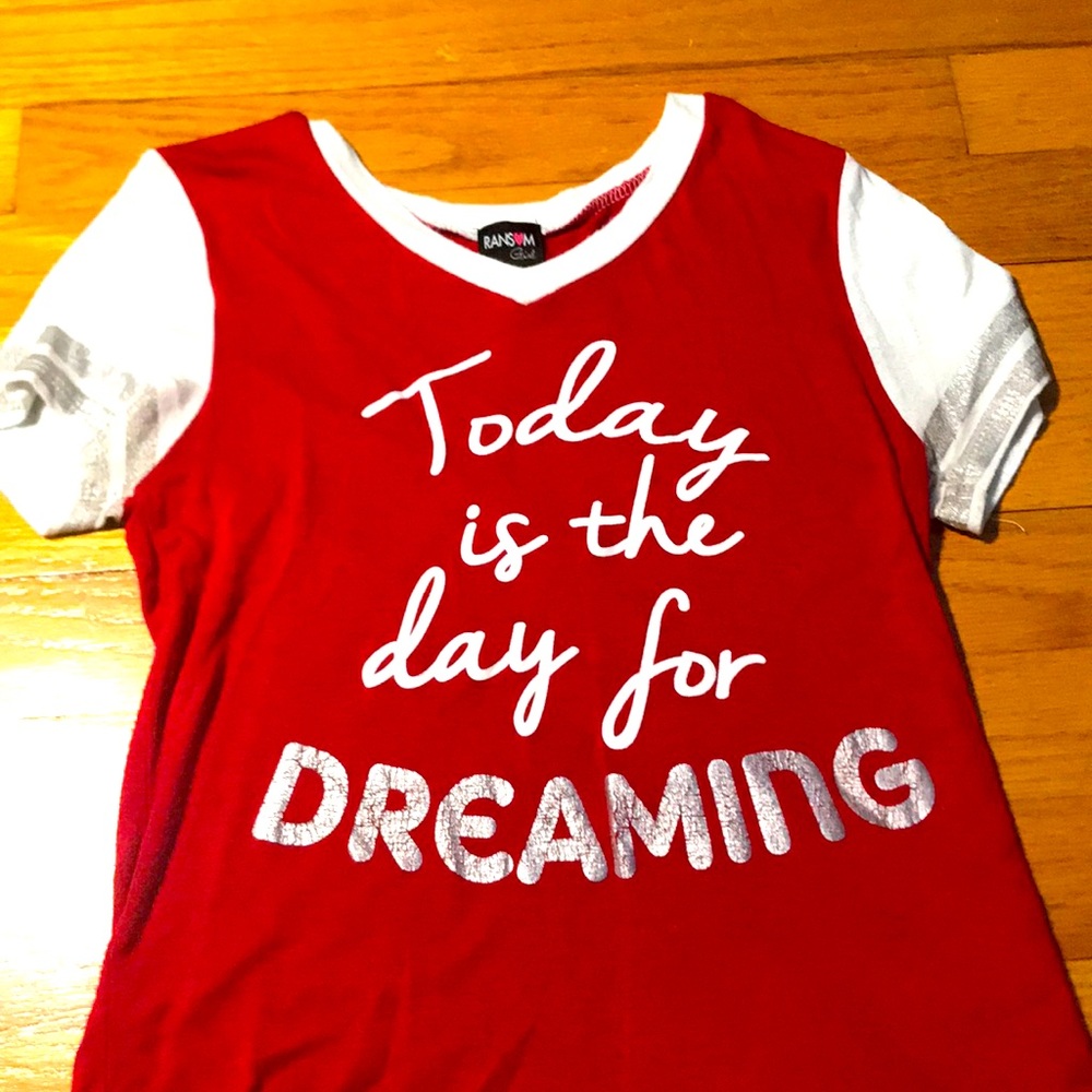 A red shirt with white words and a big grey word